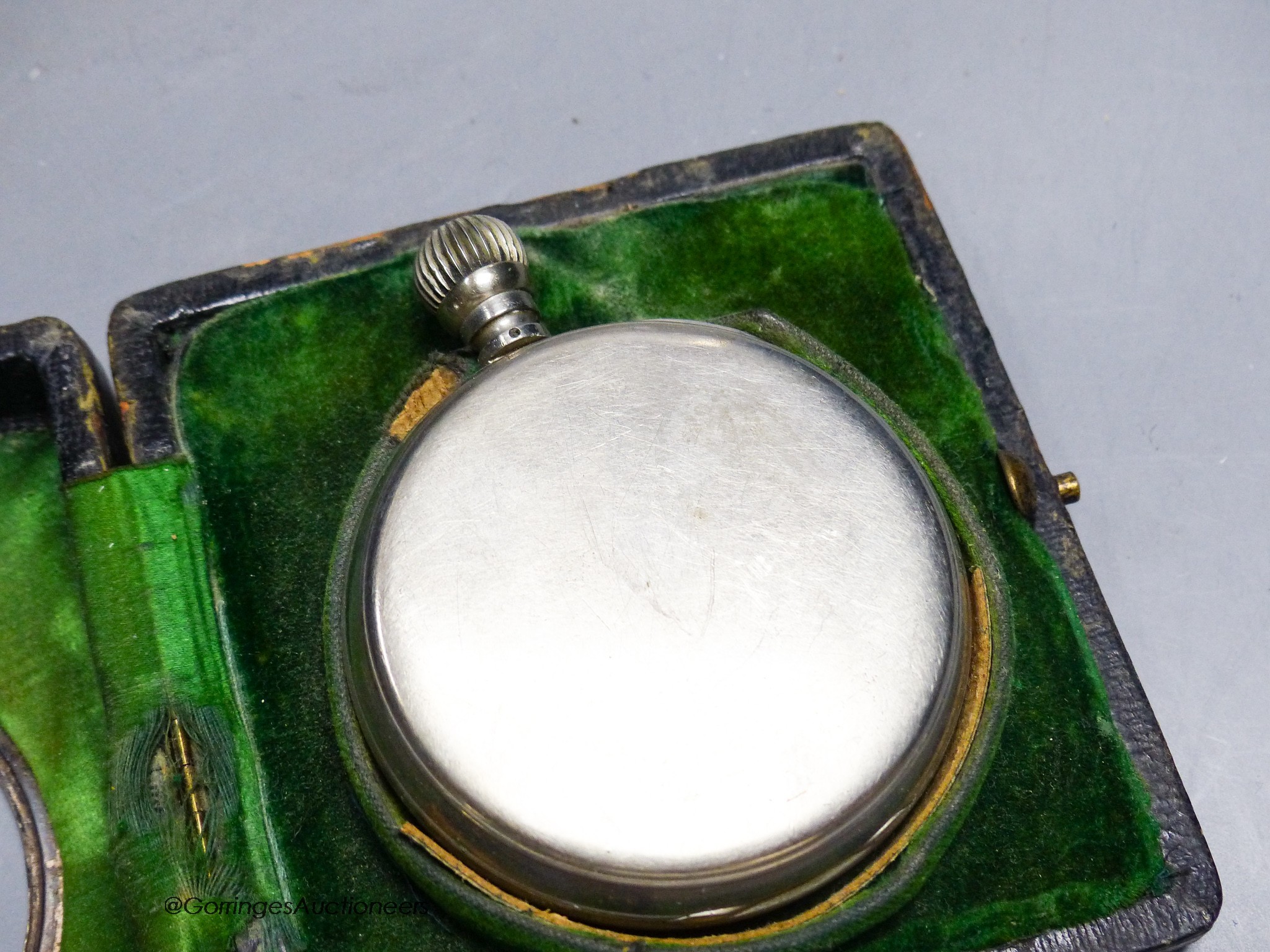 A cased carriage clock and a silver mounted motorwatch